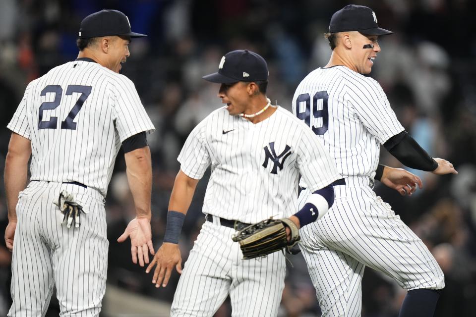 New York Yankees' Giancarlo Stanton (27) and Aaron Judge (99) celebrate with teammates after a baseball game against the Philadelphia Phillies, Monday, April 3, 2023, in New York. (AP Photo/Frank Franklin II)