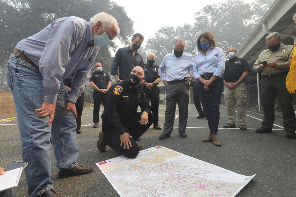 Representative Mike Thompson, left, listens to director of Cal Fire Thom Porter talk about the Glass Fire with Governor Gavin Newsom, Senator Bill Dodd and Assemblywoman Cecilia Aguiar-Curry near St. Helena, Calif., Thursday, Oct. 1, 2020. (Christopher Chung/The Press Democrat via AP, Pool)