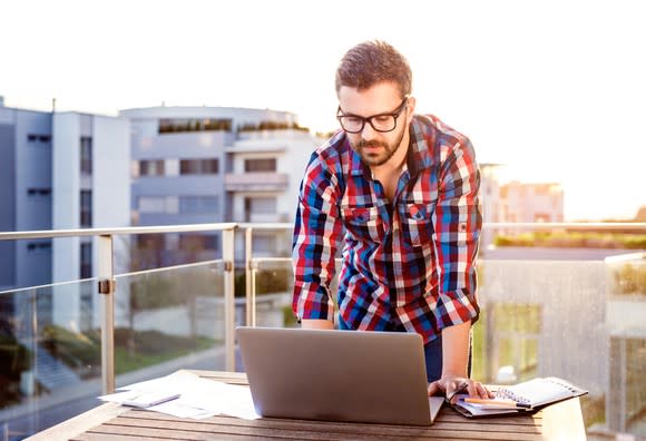 Man at laptop on rooftop