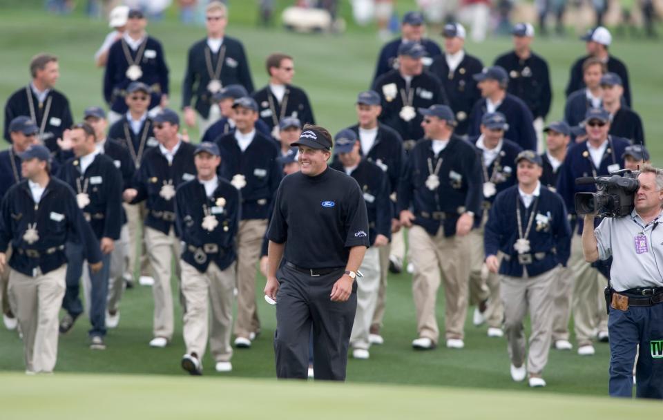 Golfer Phil Mickelson is followed by the Thunderbirds in February 2005. The Thunderbirds wear Indigenous-inspired pendants and belts.