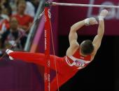 Sam Oldham of Britain falls from the horizontal bar during the men's gymnastics team final in the North Greenwich Arena during the London 2012 Olympic Games July 30, 2012.