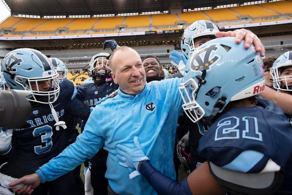 Central Valley coach Mark Lyons celebrates with his team after winning the WPIAL Class 3A championship game against North Catholic, Saturday at Heinz Field.