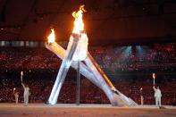 <p>A lopsided Olympic flame was lit during the 2010 Vancouver Winter Olympics Opening Ceremony. An arm that was supposed to rise up a meet the other three malfunctioned, leaving one torchbearer with nothing to do. (Photo by Cameron Spencer/Getty Images) </p>