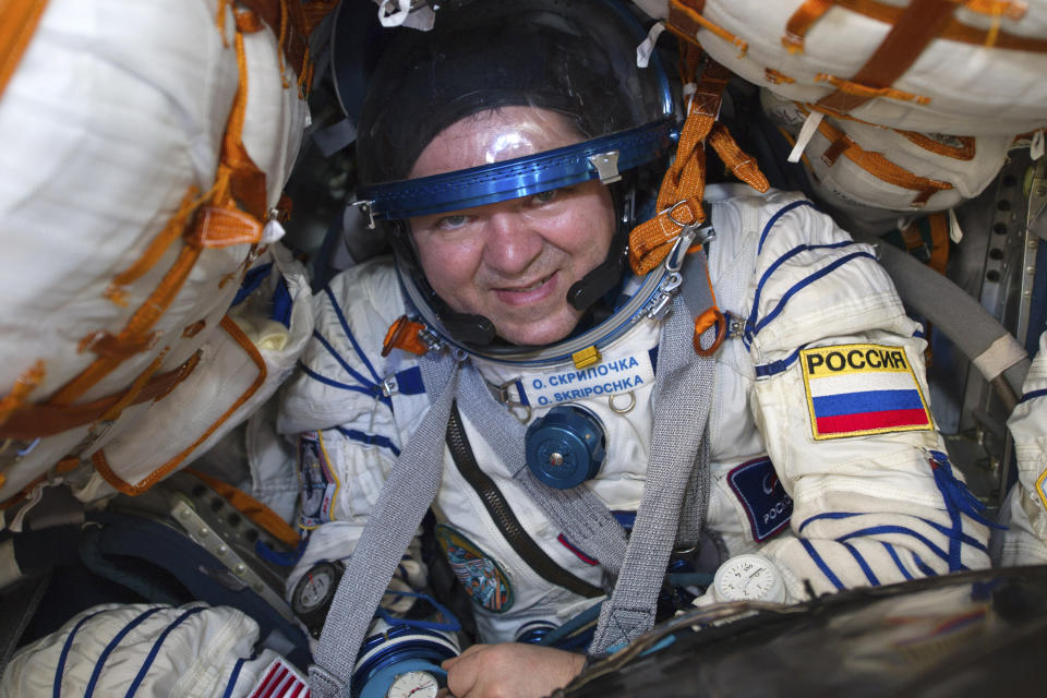 In this handout photo released by Gagarin Cosmonaut Training Centre (GCTC), Roscosmos space agency, Russian space agency Roscosmos' Oleg Skripochka sits in the capsule shortly after the landing of the Russian Soyuz MS-15 space capsule near Kazakh town of Dzhezkazgan, Kazakhstan, Friday, April 17, 2020. An International Space Station crew has landed safely after more than 200 days in space. The Soyuz capsule carrying NASA astronauts Andrew Morgan, Jessica Meir and Russian space agency Roscosmos' Oleg Skripochka touched down on Friday on the steppes of Kazakhstan. (Andrey Shelepin, Gagarin Cosmonaut Training Centre (GCTC), Roscosmos space agency, via AP)