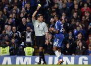 Chelsea's Samuel Eto'o (R) is shown a yellow card by referee Andre Marriner after celebrating his goal against West Bromwich Albion during their English Premier League soccer match at Stamford Bridge in London November 9, 2013.