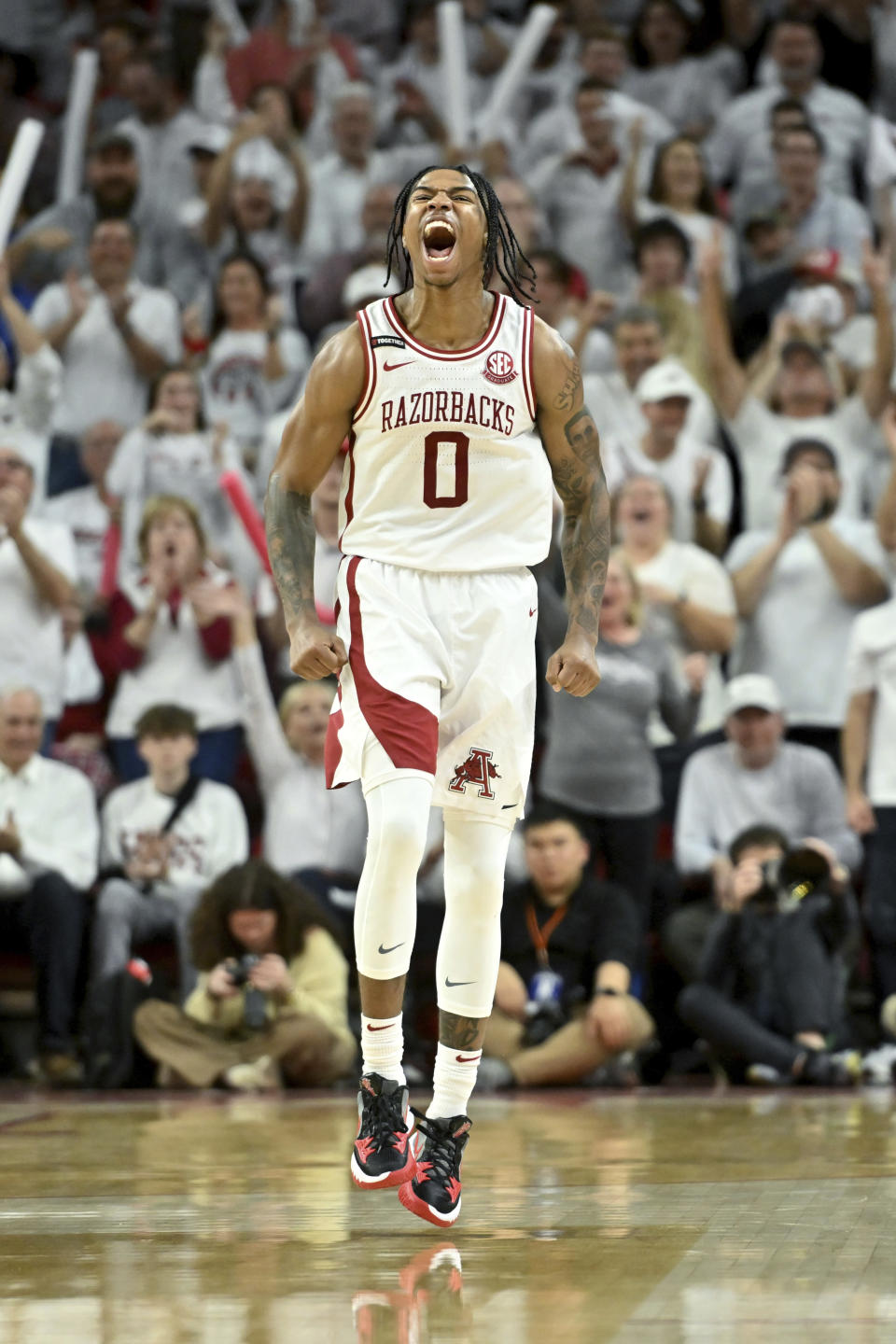 Arkansas guard Khalif Battle (0) reacts after hitting a three-point shot against Duke during the second half of an NCAA college basketball game Wednesday, Nov. 29, 2023, in Fayetteville, Ark. (AP Photo/Michael Woods)