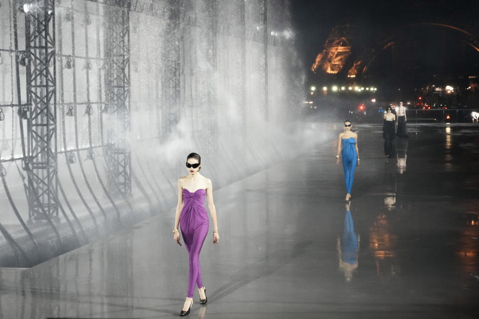 Models wear creations for Saint Laurent Spring-Summer 2022 ready-to-wear fashion show Tuesday, Sept. 28, 2021, in Paris. (AP Photo/Thibault Camus)