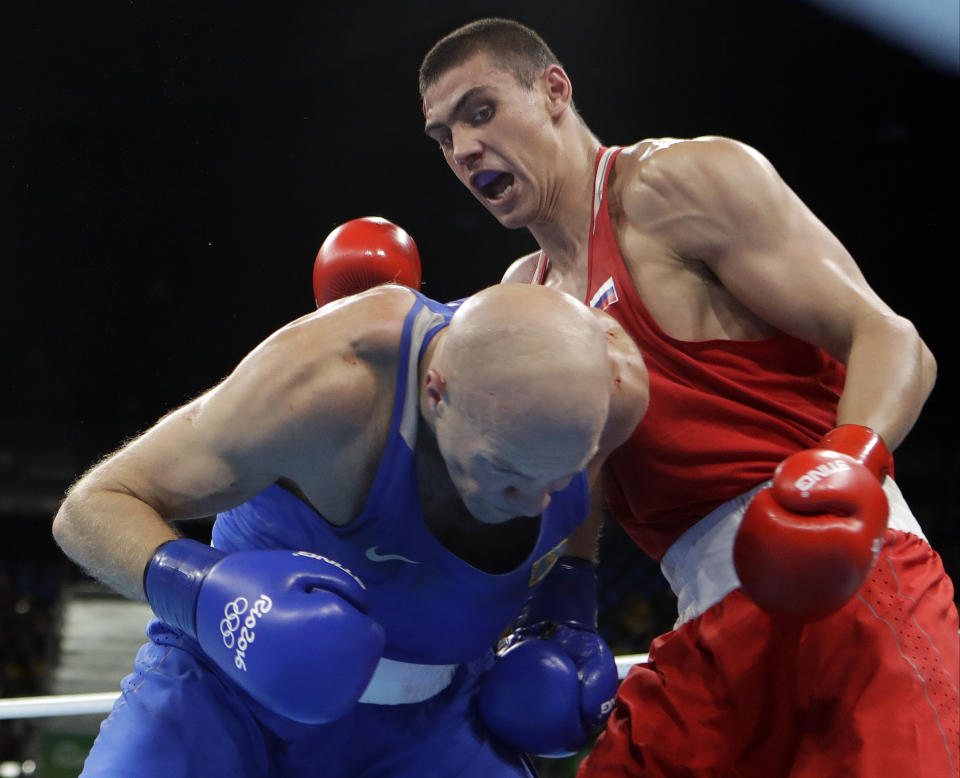 FILE - In this Monday, Aug. 15, 2016, file photo, Russia's Evgeny Tishchenko, right, fights Kazakhstan's Vassiliy Levit during a men's heavyweight 91-kg final boxing match at the 2016 Summer Olympics in Rio de Janeiro, Brazil. After a half-decade of turmoil and drama at the highest levels of Olympic boxing, the sport's trip to Tokyo looks as if it could be fairly smooth. At least as smooth as this notoriously chaotic sport ever gets.(AP Photo/Frank Franklin II, File)