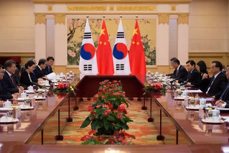 South Korea's President Moon Jae-In (2nd L) talks with China's Premier Li Keqiang (2nd R) at the Great Hall of the People in Beijing, China December 15, 2017. REUTERS/Nicolas Asfouri/Pool