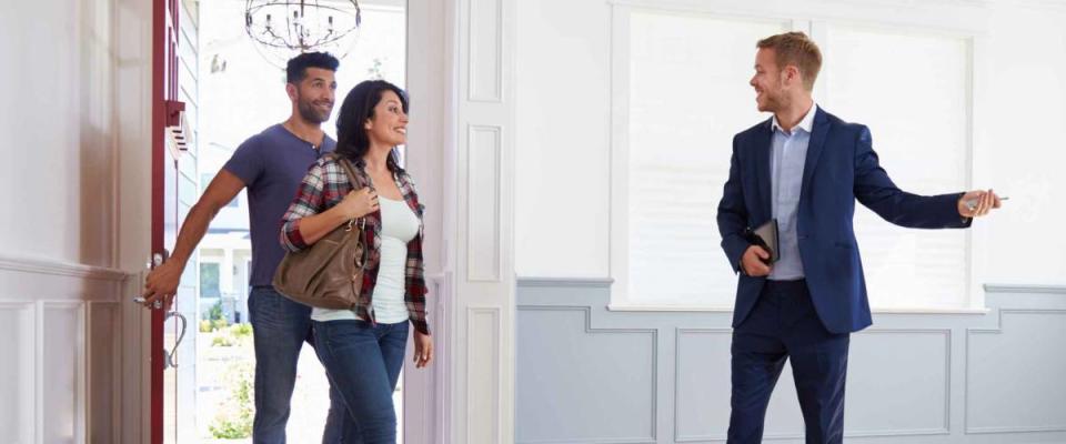 Realtor Showing Hispanic Couple Around New Home