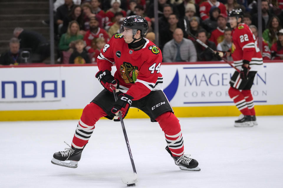 Chicago Blackhawks defenseman Wyatt Kaiser handles the puck during the first period of the team's NHL hockey game against the Colorado Avalanche on Tuesday, Dec. 19, 2023, in Chicago. (AP Photo/Erin Hooley)