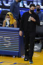 Injured Golden State Warriors guard Klay Thompson, right, walks next to guard Stephen Curry during the first half of the team's NBA basketball game against the New York Knicks in San Francisco, Thursday, Jan. 21, 2021. (AP Photo/Jeff Chiu)