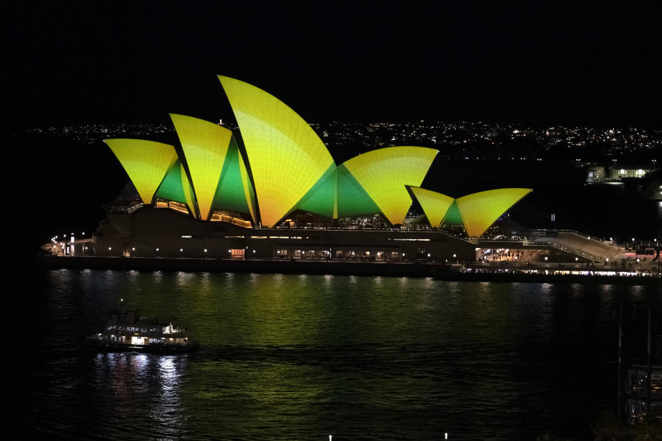 The Opera House in Sydney is illuminated with the Australia's color on the occasion of the Women World Cup third place soccer match between Sweden and Australia, Saturday, Aug. 19, 2023. (AP Photo/Alessandra Tarantino)