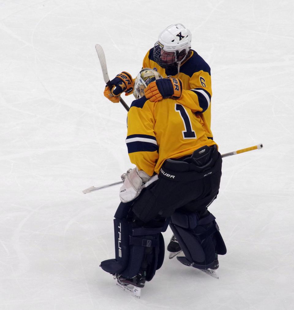 Xavarian goalie Cole Pouliot-Porter gets a consoling hug from teammate Michael Rossi after coming up short against Pope Francis, 3-2, in the final seconds of the game at TD Garden on Sunday, March 19, 2023.