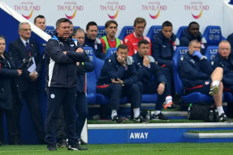 Leicester City's manager Craig Shakespeare (L) watches from the touchline during their match against Stoke City at King Power Stadium in Leicester, central England on April 1, 2017