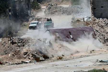 Forces loyal to Syria's President Bashar al-Assad are seen near barricades after they advanced on the southern side of the Castello road in Aleppo, Syria, in this handout picture provided by SANA on July 28, 2016. SANA/Handout via REUTERS