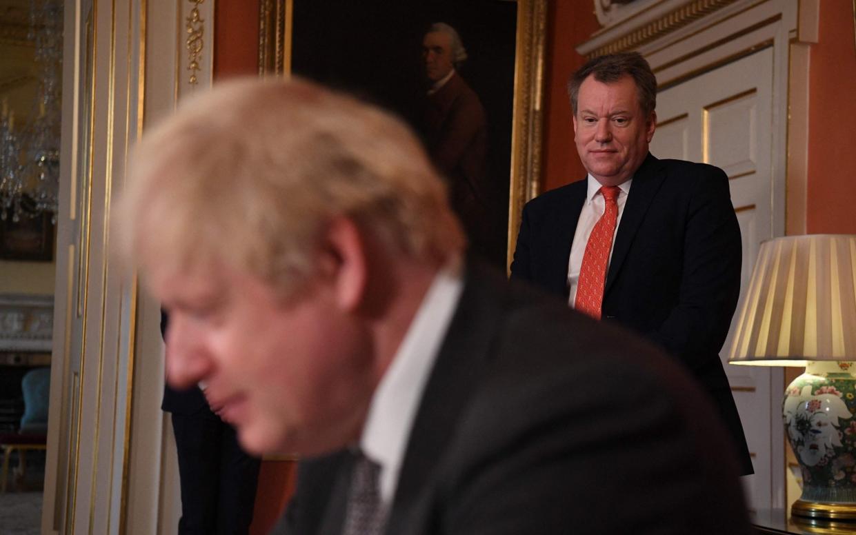In this photo taken on Dec 30, 2020, David Frost looks on as Boris Johnson signs the Trade and Cooperation Agreement between the UK and the EU - Leon Neal/ AFP