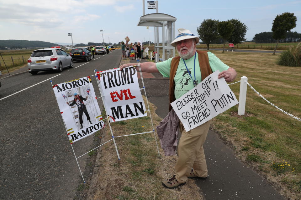 <p>Protesters gather on the A719 near Turnberry, where President Trump and first lady Melania Trump are spending the weekend at the Trump Turnberry resort in South Ayrshire, Scotland. (Photo: Andrew Milligan/PA Images via Getty Images) </p>