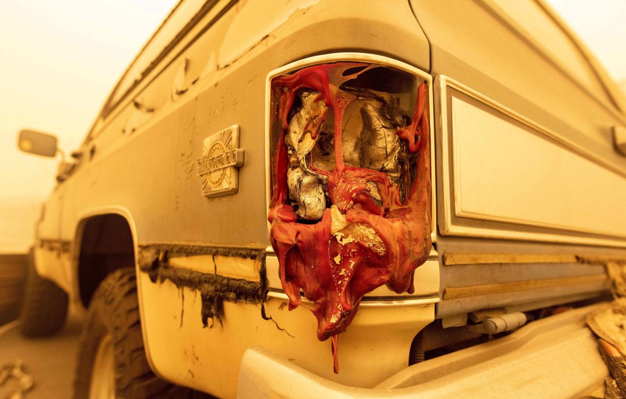 A melted tail light is seen on a fire-damaged vehicle in Greenville, Calif. on Aug. 6, 2021.