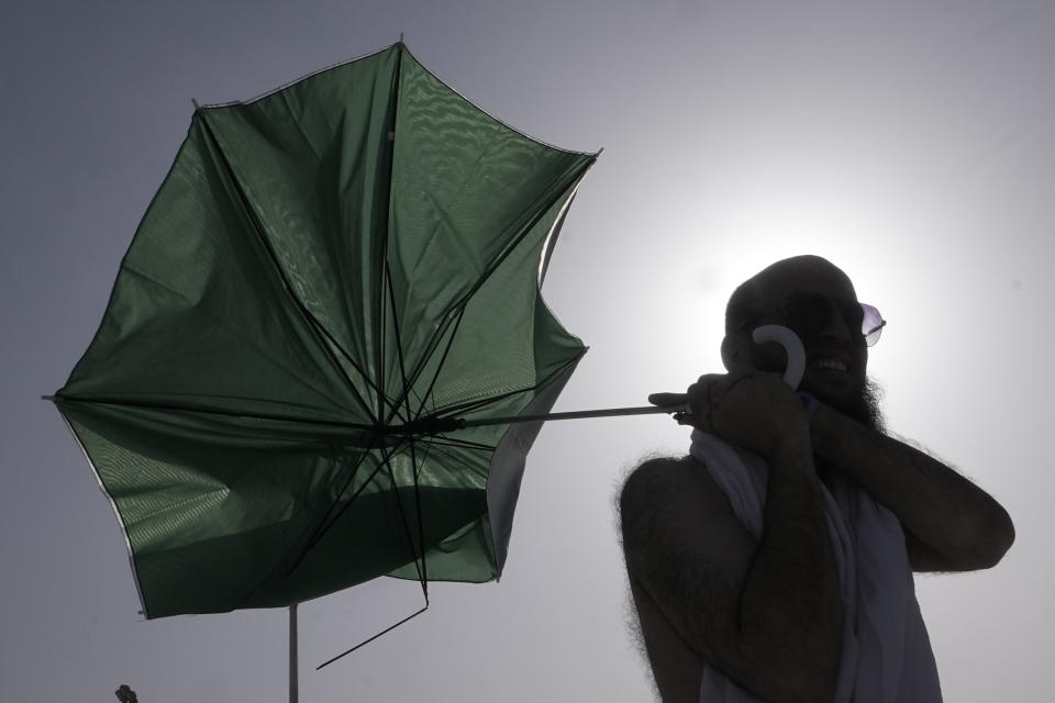 A pilgrim walks to cast stones at a pillar in the symbolic stoning of the devil, the last rite of the annual Hajj pilgrimage, in Mina near the holly city of Mecca, Saudi Arabia, Wednesday, June 28, 2023. (AP Photo/Amr Nabil)