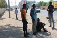 Migrants are seen on the street, after being rescued by Libyan coast guard, in Misrata