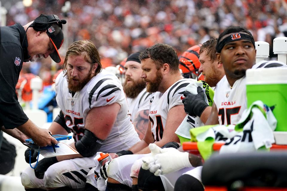 Cincinnati Bengals offensive line coach Frank Pollack, left, talks with Cincinnati Bengals guard Alex Cappa (65), Cincinnati Bengals guard Max Scharping (74) and Cincinnati Bengals guard Cordell Volson (67) in the fourth quarter of an NFL football game between the Cincinnati Bengals and Cleveland Browns, Sunday, Sept. 10, 2023, at Cleveland Browns Stadium in Cincinnati.