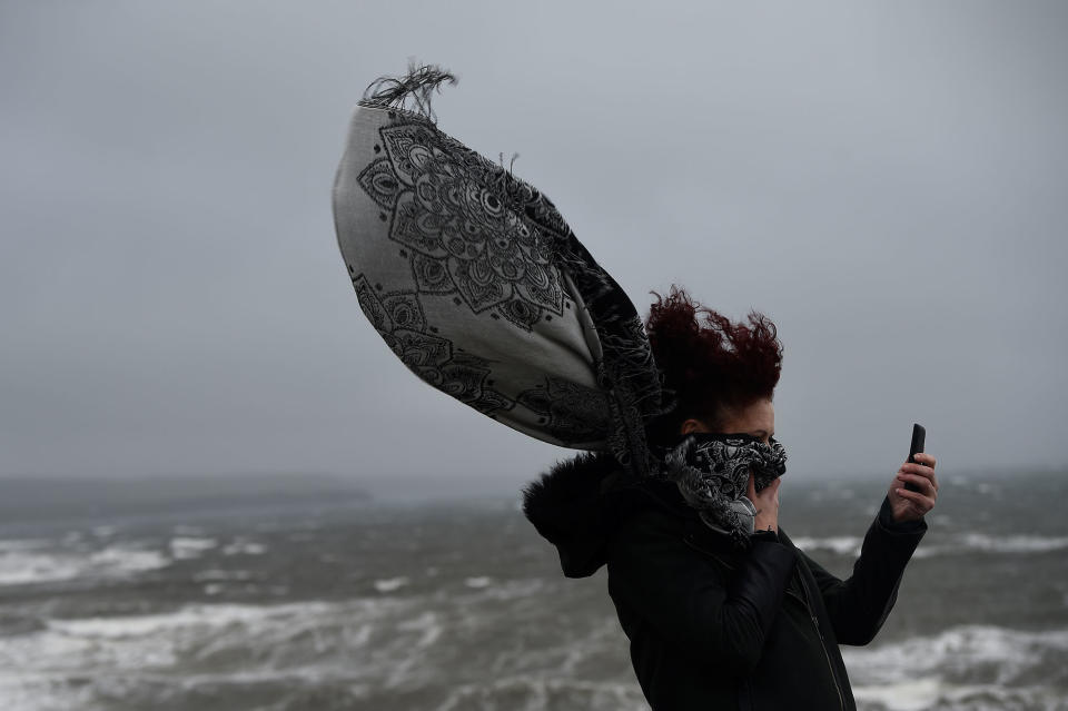 <p>A woman takes a picture during storm Ophelia in the County Clare town of Lahinch, Ireland, Oct.16, 2017. (Photo: Clodagh Kilcoyne/Reuters) </p>