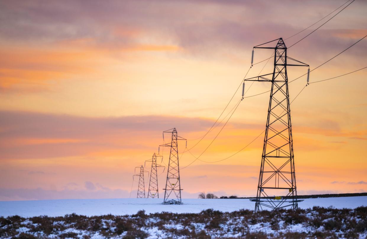 A view of electric pylons in the Scottish Borders. Pictured on a cold snowy day in winter.  Pic Phil Wilkinson / Alamy