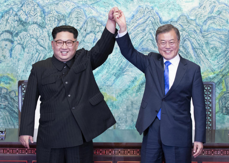 FILE - North Korean leader Kim Jong Un, left, and South Korean President Moon Jae-in raise their hands after signing on a joint statement at the border village of Panmunjom in the Demilitarized Zone, South Korea on April 27, 2018. Since assuming power 10 years ago, North Korean leader Kim Jong Un has ruled the isolated country with absolute power, significantly expanded its nuclear arsenal and become the North’s first ruler to hold a summit with a sitting U.S. president. But now, he’s hunkering down and struggling to revive a dilapidated economy battered hard by pandemic-related border shutdowns, toughened U.N. sanctions and mismanagement. (Korea Summit Press Pool via AP, File)