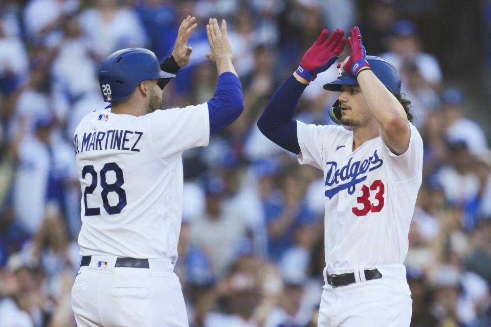 James Outman celebrates with designated hitter J.D. Martinez after hitting a home run.