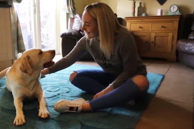 A young woman who suffers up to 100 seizures a day has revealed she's regularly rescued by her dog