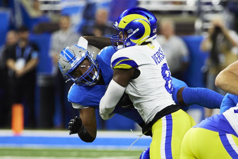 Lions running back David Montgomery (5) is tackled by Rams linebacker Jared Verse (8).