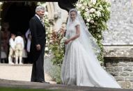 <p>The bride arrived to the church looking gorgeous in a <a rel="nofollow" href="https://www.yahoo.com/style/pippa-middleton-marries-james-matthews-lace-giles-deacon-gown-113157258.html" data-ylk="slk:bespoke lace gown;elm:context_link;itc:0;sec:content-canvas;outcm:mb_qualified_link;_E:mb_qualified_link;ct:story;" class="link  yahoo-link">bespoke lace gown</a> by British designer Giles Deacon. She completed her floor-sweeping look with a veil by milliner Stephen Jones. (Photo: PA) </p>