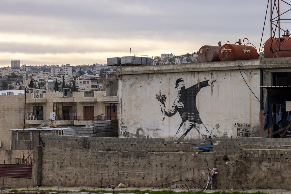 Banksy graffiti 'Rage, Flower Thrower' in Bethlehem, West Bank. In November, the elusive artist's identity was revealed for the first time. (Maja Hitij/Getty Images)