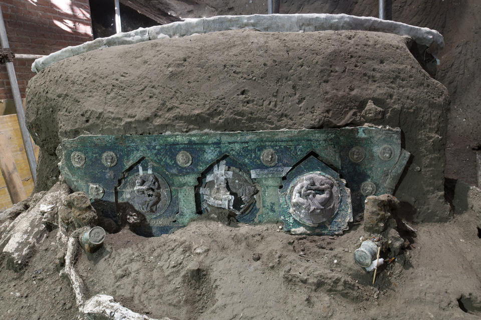 A view of a chariot, with its iron elements, bronze decorations and mineralized wooden remains, that was found in Civita Giuliana, north of Pompeii. Officials at the Pompeii archaeological site near Naples on Saturday, Feb. 27, 2021, announced the first-ever discovery of an intact ceremonial chariot, one of several important discoveries made in the same area outside the park following an investigation into an illegal dig. (Parco Archeologico di Pompei via AP)