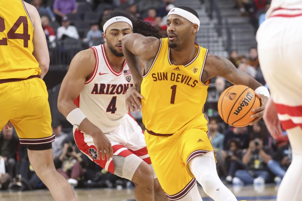 Arizona State guard Luther Muhammad drives to the basket against Arizona guard Kylan Boswell.