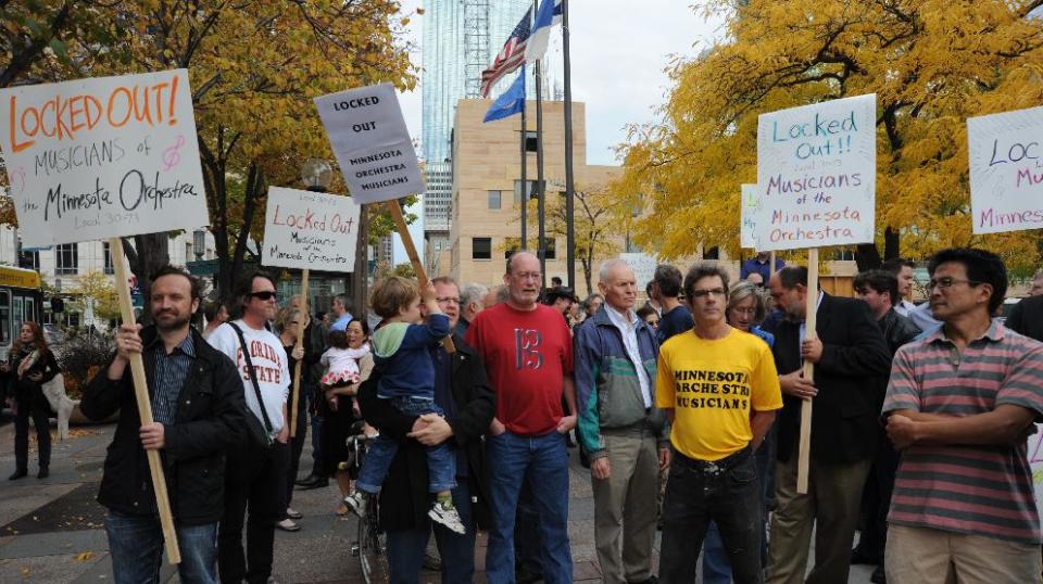 In this photo taken Monday Oct. 1, 2012, Minnesota Orchestra musicians locked out in contract dispute rally at 11th St and Nicollet Mall near Peavey Plaza in Minneapolis, Minn. The Minnesota Orchestra was called the world's greatest not long ago, welcome recognition for musicians outside a top cultural center. Now its members are locked out of Orchestra Hall, stuck in the same kind of labor-management battle recently afflicting teachers and football referees. (AP Photo/The Star Tribune, Richard Sennott)