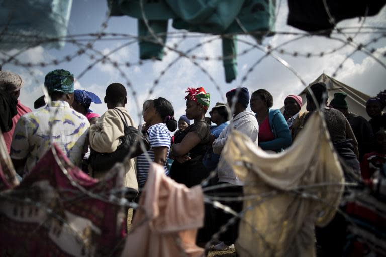 Displaced people who fled the anti-immigrant violence are seen in a camp on April 19, 2015 in the village of Primrose, east of Johannesburg