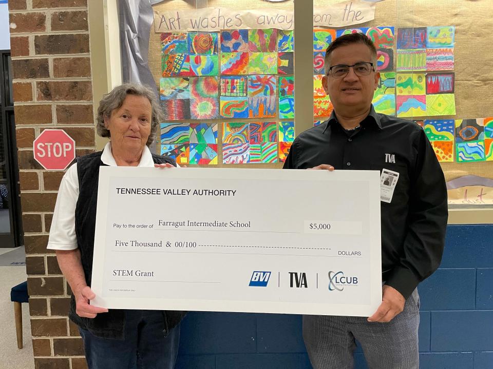 Reny Lee with Bicentennial Volunteers Inc. (TVA’s retiree organization) and Robbie Ansary with TVA present a $5,000 check to Farragut Intermediate School for STEM projects, May 9, 2024.