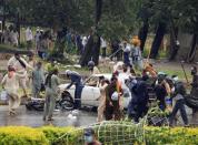 Supporters of Tahir ul-Qadri, Sufi cleric and leader of political party Pakistan Awami Tehreek (PAT), use sticks to hit a car and a motorcycle as they protest during Revolution March towards the prime minister's house in Islamabad September 1, 2014. REUTERS/Faisal Mahmood