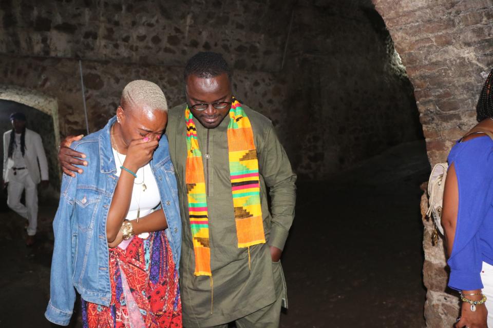 A tour guide comforts NAACP Youth and College Director Tiffany Dena Loftin iinside the Cape Coast Slave Castle on Ghana's coast. 
Africans captured by slave traders were herded inside small dungeons and endured horrendous conditions before being put on a ship to lands unknown. Those who died were thrown to the sharks; those who survived were sent across the sea in chains.