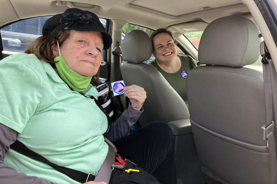 Anne-Marie Angelo and her mother Patricia Angelo hop in the car in Virginia Beach, Va., after voting for governor in the state's Democratic primary. Anne-Marie Angelo said she voted for Jennifer Carroll Foy because of her progressive stances on gun control, healthcare and policing. Patricia Angelo said she voted for Terry McAuliffe because of his past experience as governor and the broad spectrum of opinions that he can draw from. (AP Photo/Ben Finley)