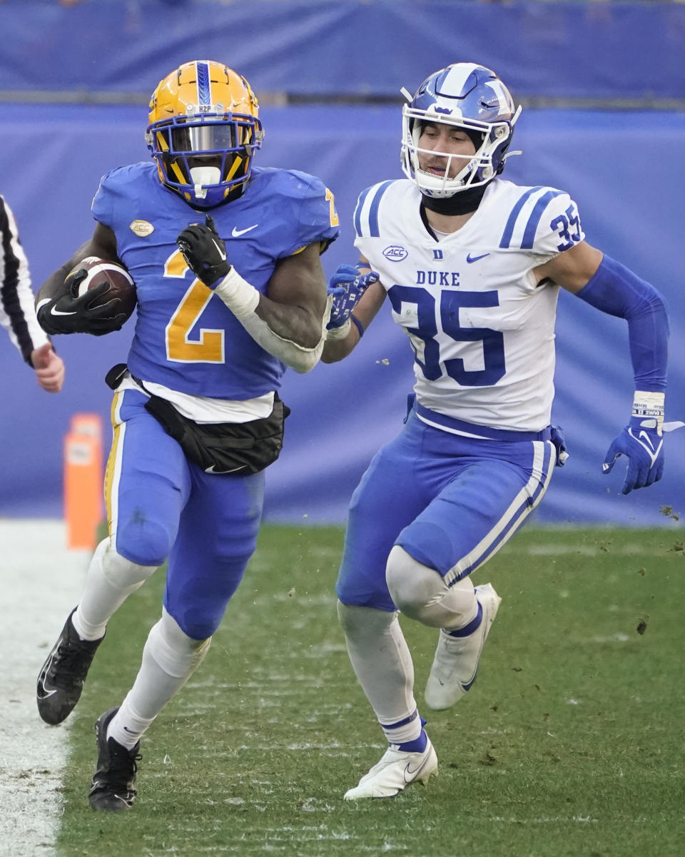 Pittsburgh running back Israel Abanikanda (2) runs away from Duke linebacker Cam Dillon (35) on a twenty yard plus run during the second half of an NCAA college football game, Saturday, Nov. 19, 2022, in Pittsburgh. Pittsburgh won 28-26. (AP Photo/Keith Srakocic)