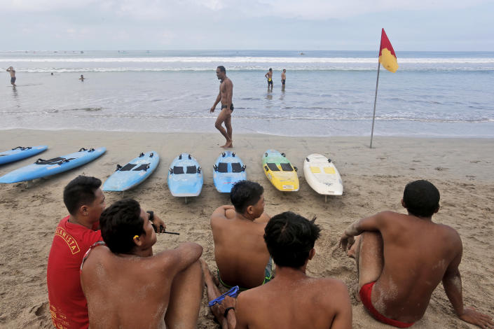 Lifeguards gather for their beach rescue training on Kuta Beach, Bali, Indonesia on Thursday, Oct. 28, 2021. Indonesians are looking ahead warily toward the upcoming holiday travel season, anxious for critical tourist spending but at the same time worried that an influx of millions of visitors could lead to a new coronavirus wave just as the pandemic seems to be getting better. (AP Photo/Firdia Lisnawati)