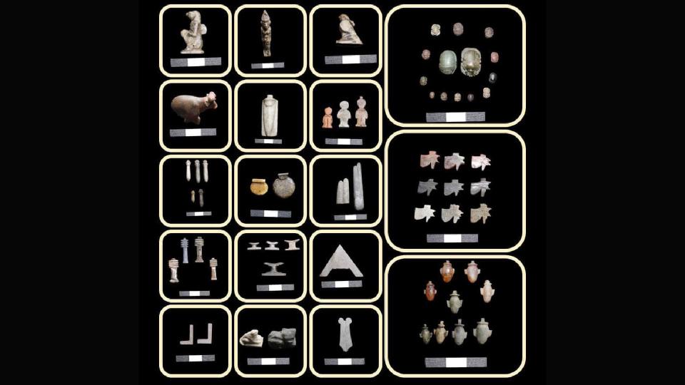 An array of small artifacts made from stone and metal including geometric objects and figurines of people and animals