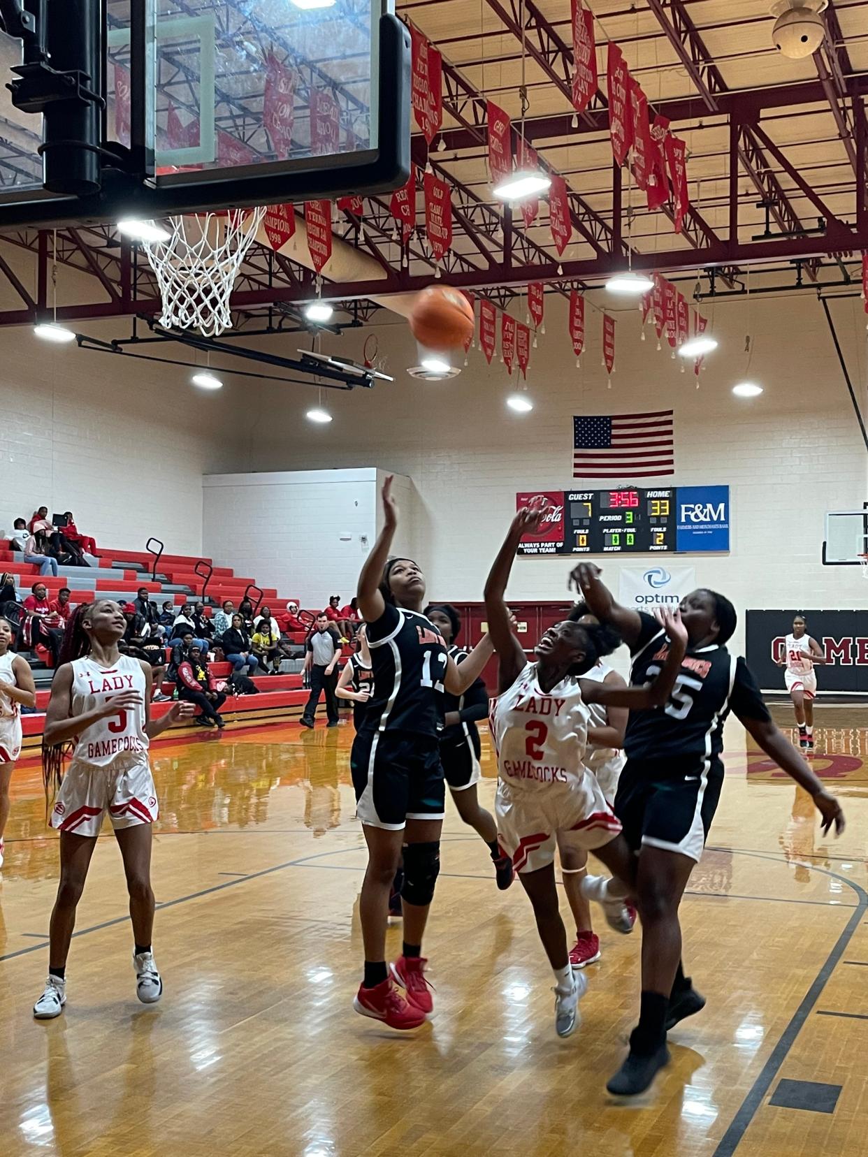 Lady Gamecock Christian Roberson (2) goes through two MCA defenders to score two on a layup in a 56-19 win over MCA last Saturday.