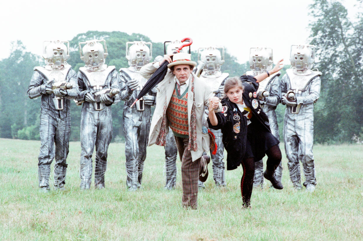 Sylvester McCoy as the Doctor and Sophie Aldred as Ace seen here on location near Arundel with the Cybermen during the filming of the Dr Who story called The Silver Nemesis, 28th June 1988. (Photo by Arthur Sidey/Mirrorpix/Getty Images)