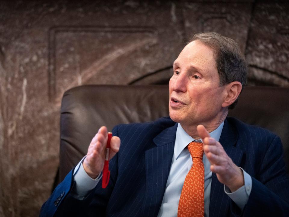 Ron Wyden speaks while sitting in a leather chair