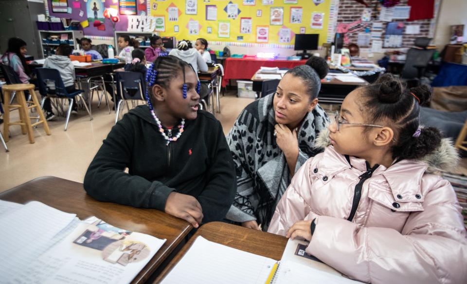 Teri Scott, a fourth-grade teacher the Cross Hill Academy in Yonkers, works with JaÕmyla Smith and Zendaya Garner on a reading assignment Jan. 8, 2023. New York Governor Kathy Hochul has announced that she will introduce legislation to require schools to use "the science of reading" curriculum. She announced that $10 million will go toward training 20,000 teachers on it. The Science of Reading is a curriculum that uses phonics, vocabulary, fluency, and comprehension to teach kids how to read.