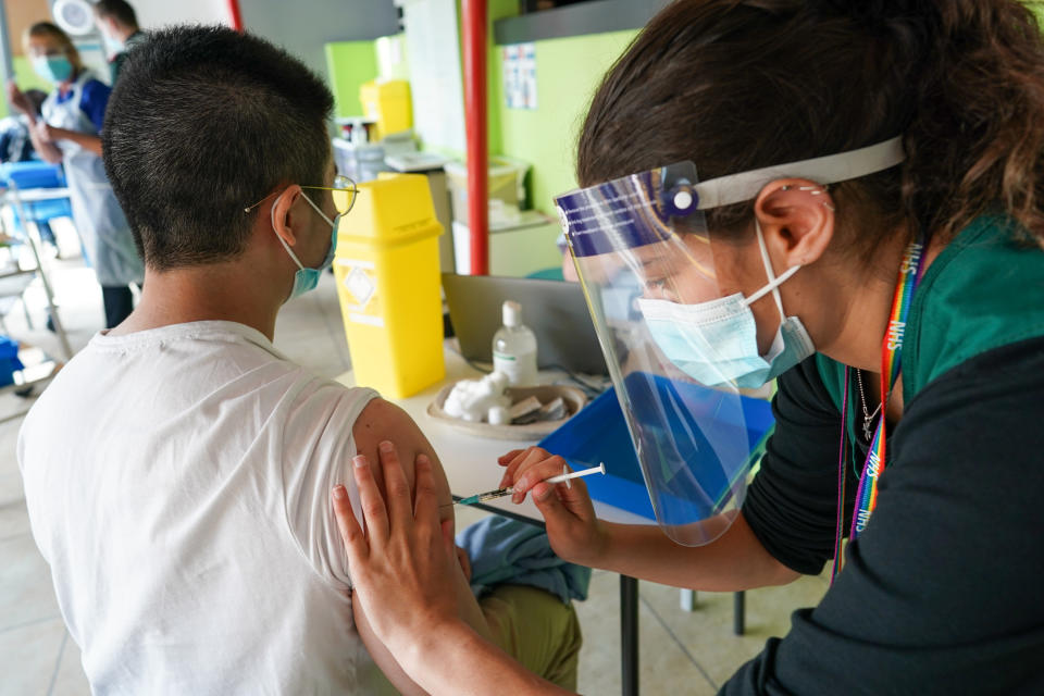 NEWCASTLE UPON TYNE, ENGLAND - JUNE 22: Chen Chen, 28, from Durham receives the Pfizer-BioNTech COVID-19 Vaccine at a new ‘Pop Up’ vaccination service on June 22, 2021 in Newcastle upon Tyne, England. The new ‘Pop Up’ vaccination service based at Times Square in Newcastle will add an additional 2000 weekly appointments, initially opening four days a week and offering up to 500 vaccinations a day, starting on Tuesday 22nd June. Vaccinations will be available from 8.30am until 7pm on a first come, first serve basis, requiring patients to collect a ticket and queue. The large vaccination centre based inside the Centre for Life continues to vaccinate people who have booked through the National Booking Service and has increased its capacity to around 1500 people a day. (Photo by Ian Forsyth/Getty Images)